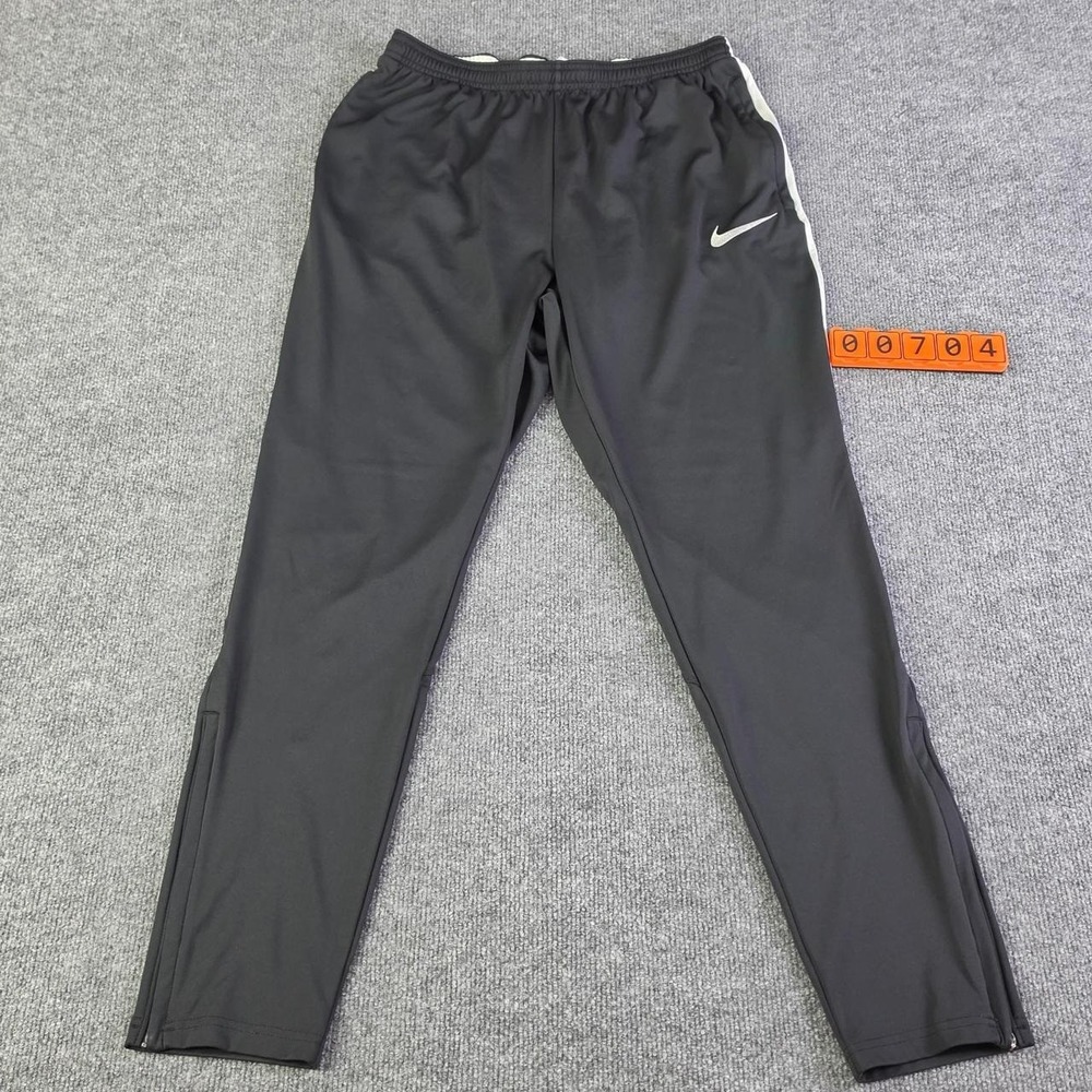 Nike Dri-Fit black track pants with white stripes on the sides, ankle zip Size M